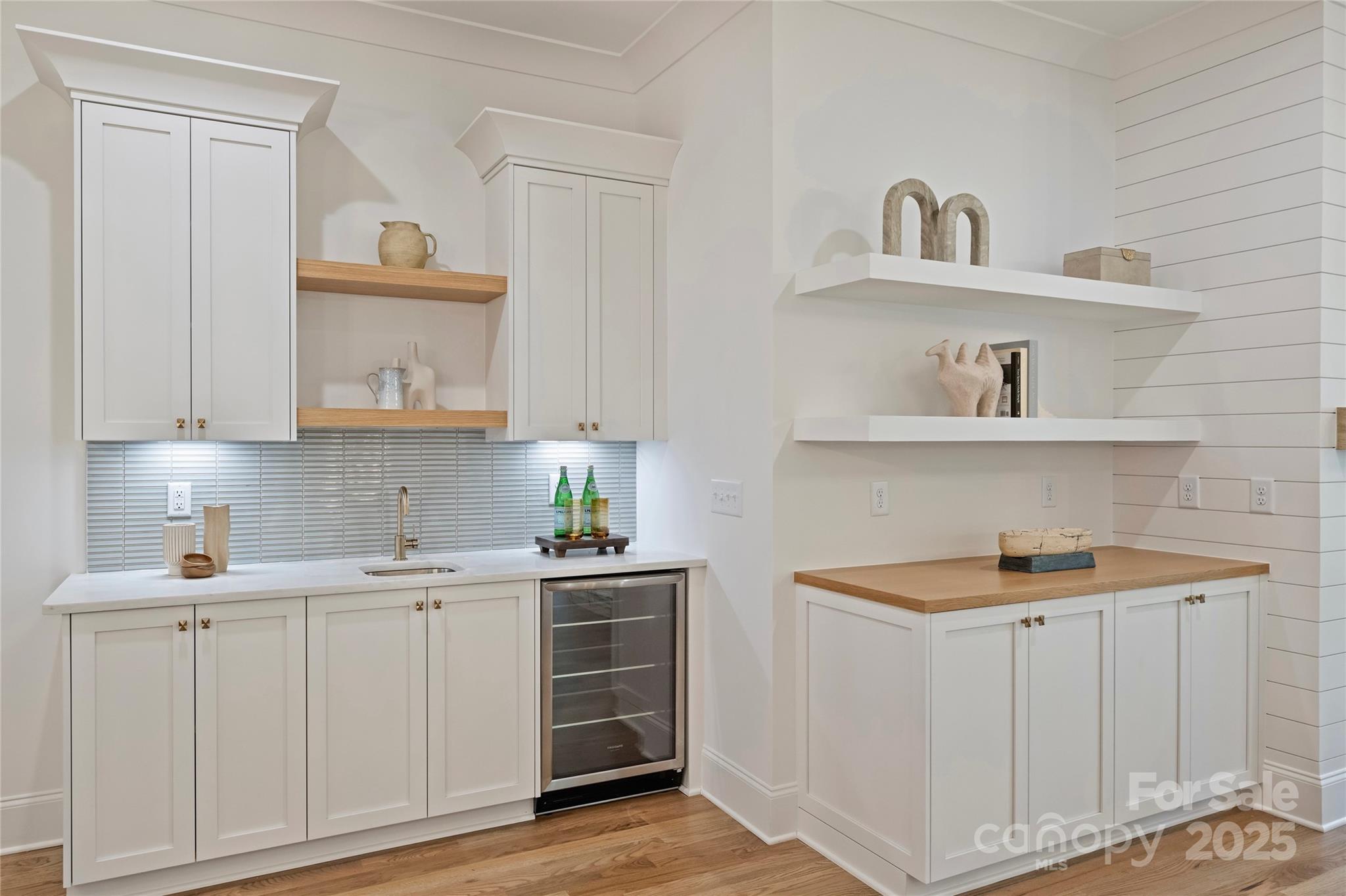522 Greystone Road Charlotte, NC 28209 - Photo 11 of 23 a view of cabinets a sink and a stove in a white room