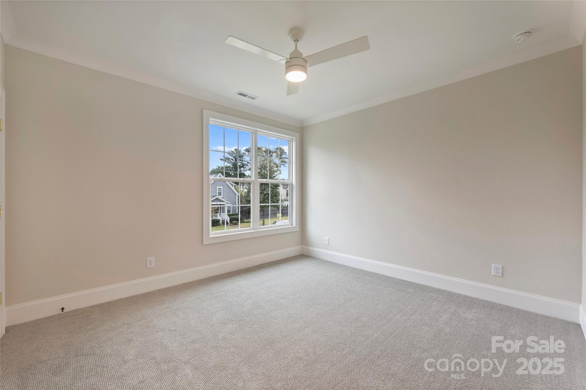 522 Greystone Road Charlotte, NC 28209 - Photo 18 of 23 an empty room with windows and ceiling fan