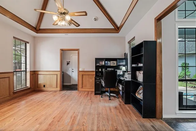 a view of workspace with wooden floor and windows