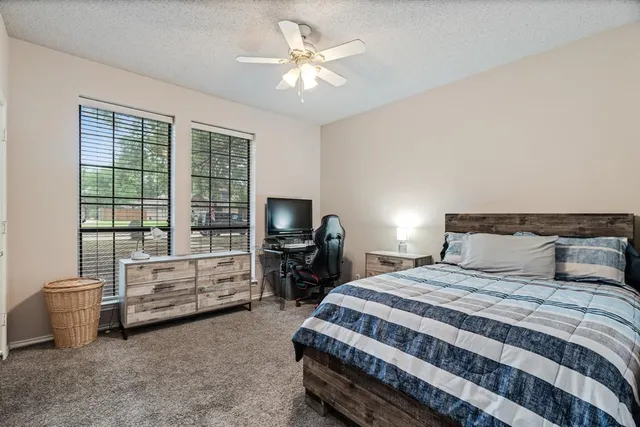 a bedroom with a bed and a view of bedroom