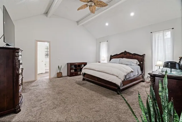 a bedroom with a bed lamp and a fireplace