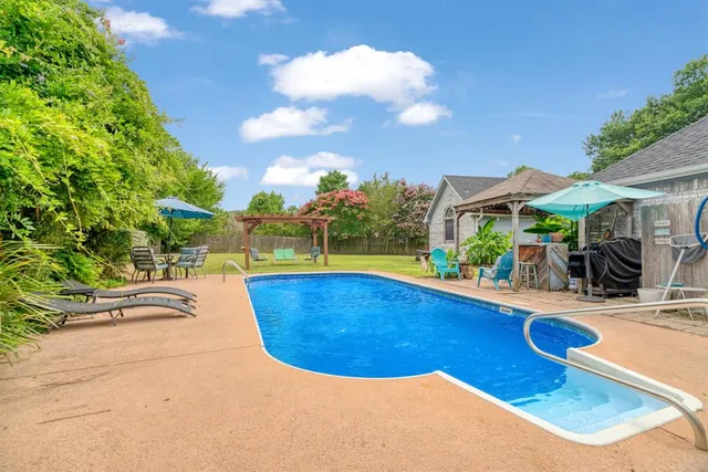 a view of a swimming pool with a patio