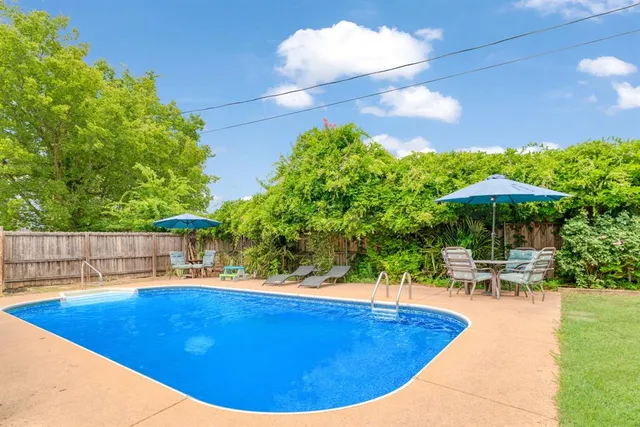 a view of a swimming pool with an outdoor seating