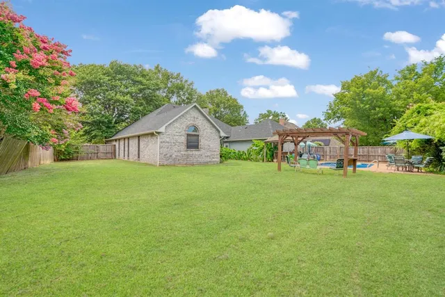 a view of an house with backyard space and garden