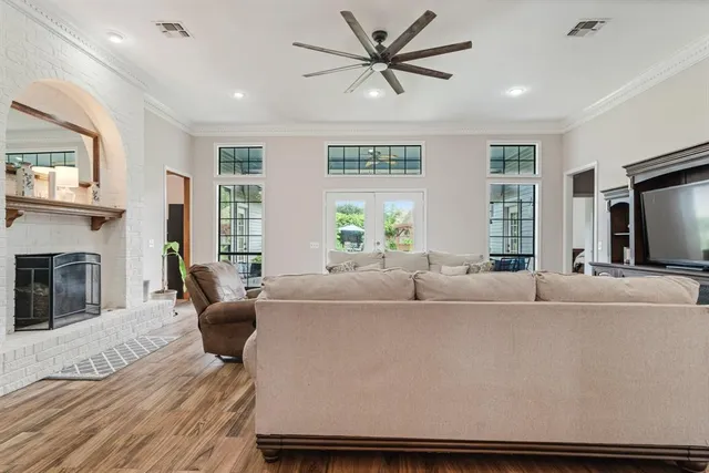 a living room with furniture a fireplace and a flat screen tv