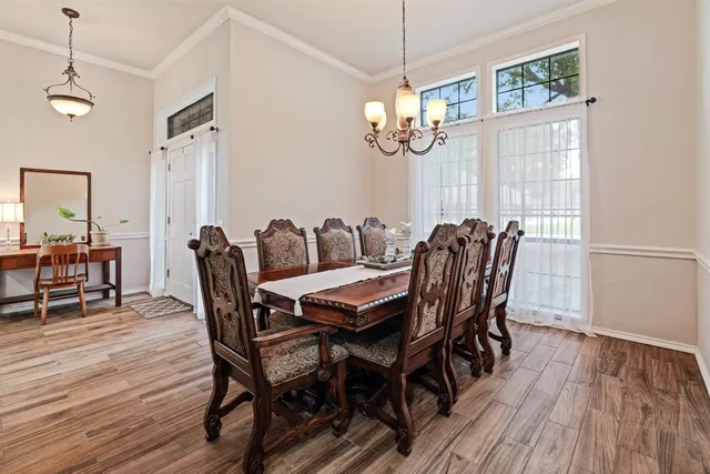 a view of a dining room with furniture wooden floor and chandelier
