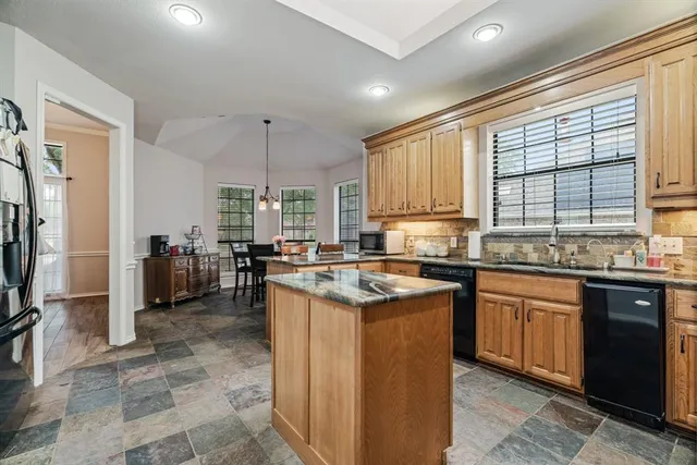 a kitchen with a stove a sink and a refrigerator