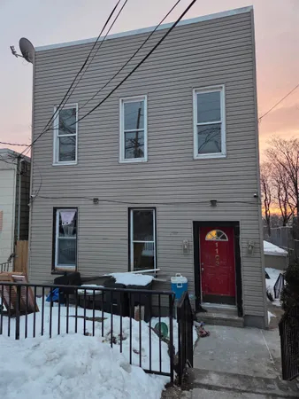a front view of a house with glass door and furniture