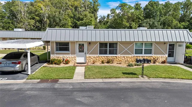 a front view of a house with a patio and a garden