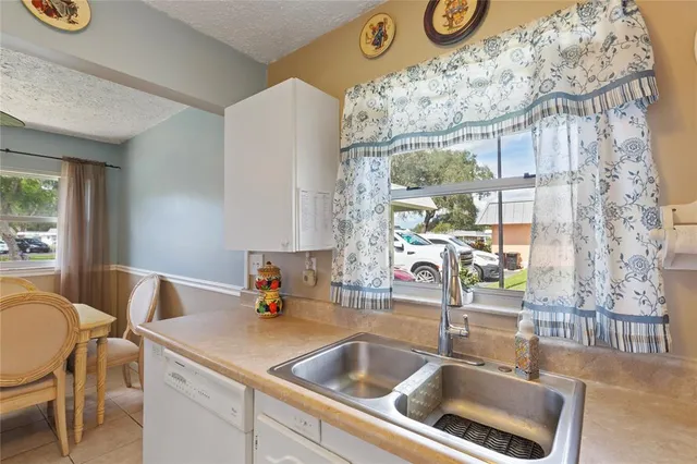 a kitchen with a sink and a refrigerator