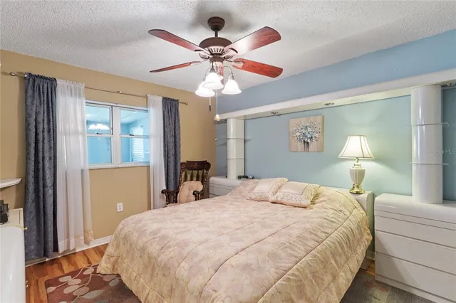 a bedroom with a large bed and a chandelier