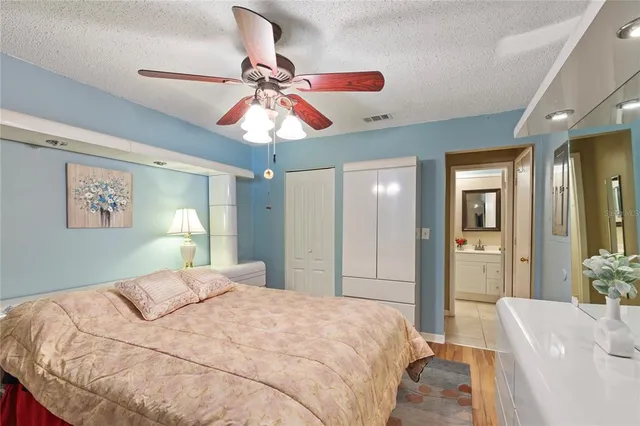 a bedroom with a bed and a chandelier