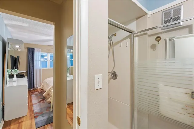 a bathroom with a glass shower door and a sink