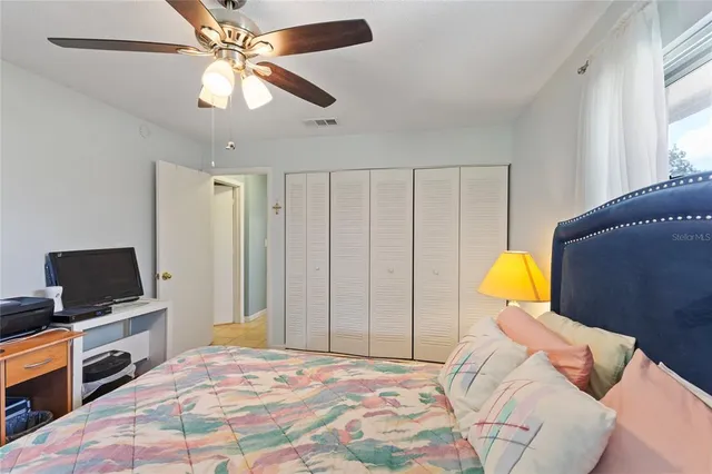 a bedroom with a bed dresser and a flat screen tv