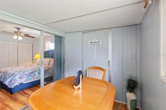 a bedroom with bed and wooden floor