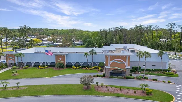 an aerial view of a house with a garden and houses