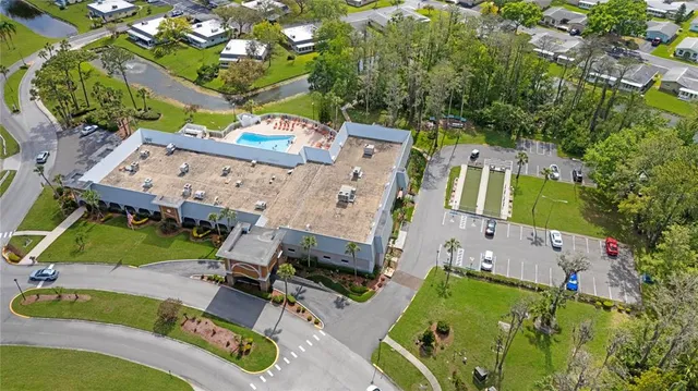 an aerial view of a house with a yard basket ball court and outdoor seating