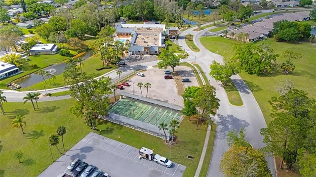 an aerial view of a house with a yard basket ball court and outdoor seating