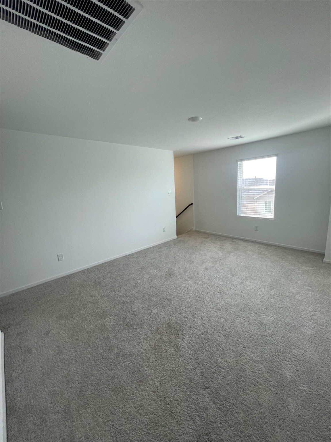 112 Stran Street Wharton, TX 77488 - Photo 11 of 23 The second-floor landing unfolds into a spacious, versatile retreat, illuminated by a large window that creates an ideal secondary living zone.