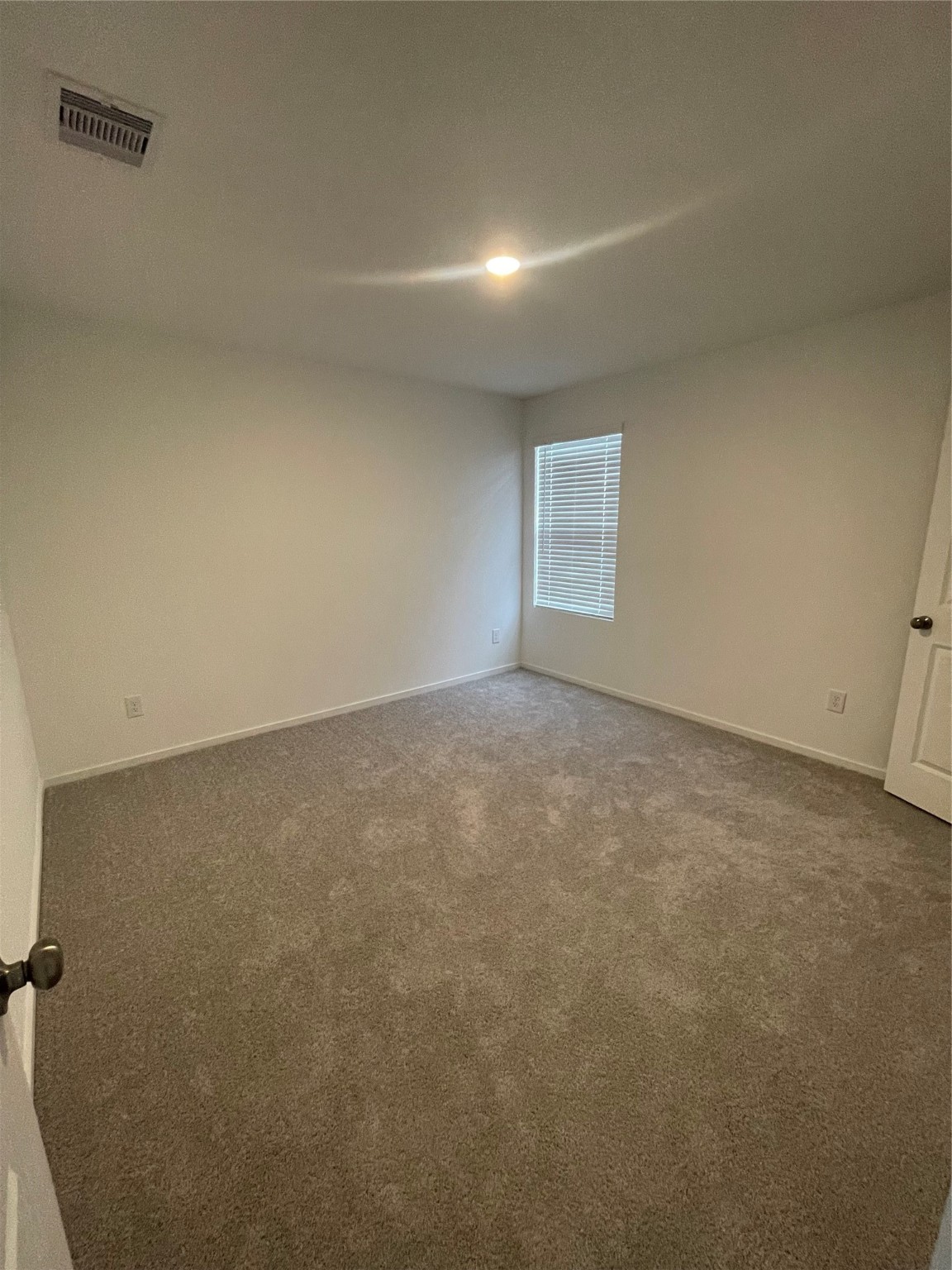 112 Stran Street Wharton, TX 77488 - Photo 16 of 23 A large window and neutral textures define this well-proportioned bedroom, perfect for guests or a dedicated creative studio.