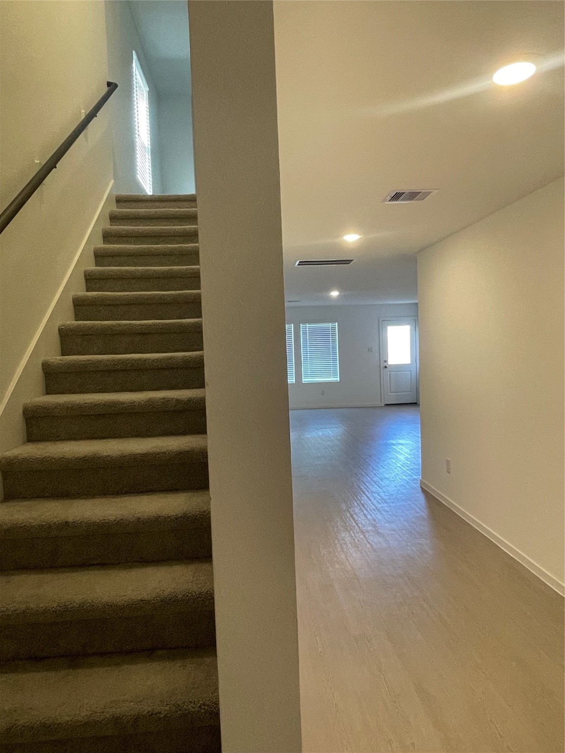 112 Stran Street Wharton, TX 77488 - Photo 10 of 23 Enclosed carpeted stairs offer a quiet, soft-textured passage to the home’s more private upper-level quarters.