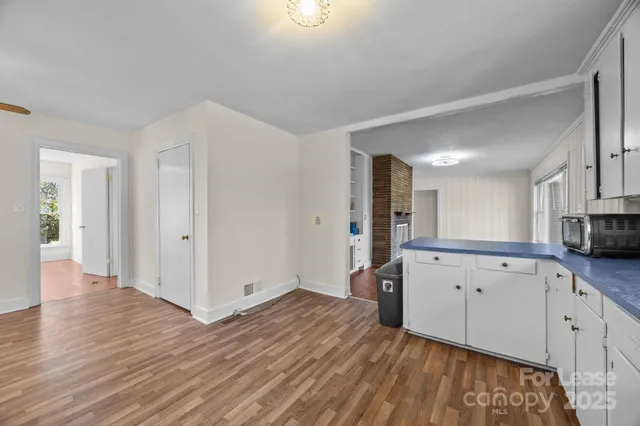 a view of a kitchen with wooden floor