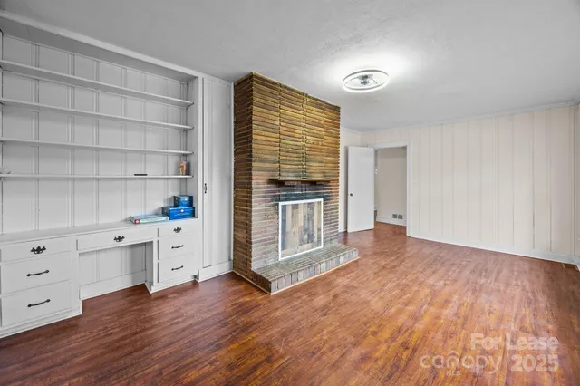 a view of wooden floor and windows in a room