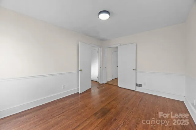 an empty room with wooden floor