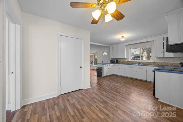 a view of a kitchen with a sink cabinets and wooden floor