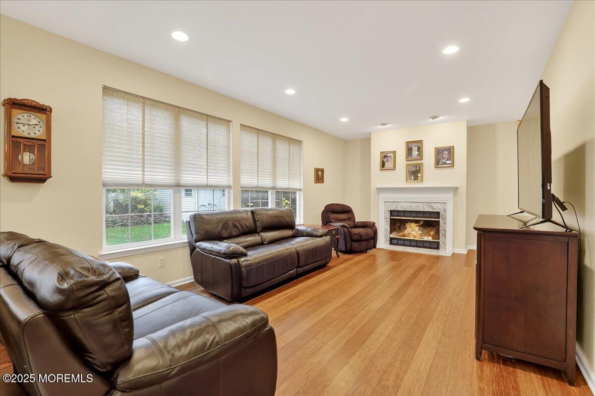 508 Lanzaro Drive Morganville, NJ 07751 - Photo 19 of 48 a living room with furniture flat screen tv and a fireplace