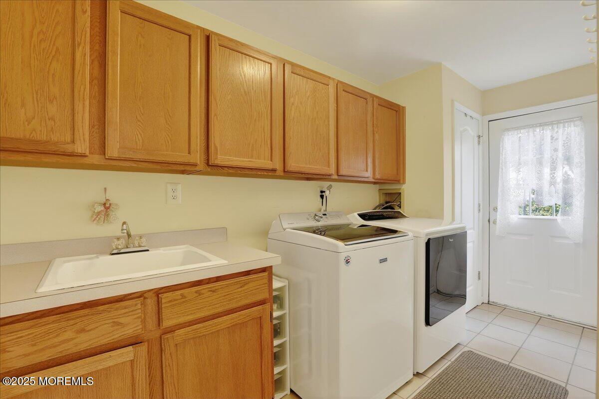 508 Lanzaro Drive Morganville, NJ 07751 - Photo 21 of 48 a view of a sink and dishwasher with wooden cabinets