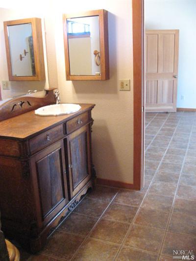 21125 A Loconomi Road Middletown, CA 95461 - Photo 12 of 12 a bathroom with a sink vanity and a mirror