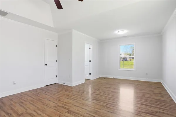 wooden floor in an empty room with a window