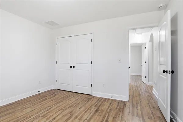 a view of a room with wooden floor