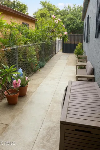 a view of a patio with chair and potted plants
