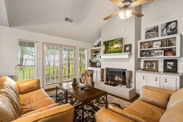 a living room with furniture fireplace and flat screen tv
