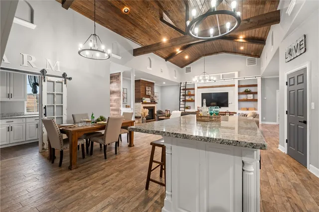 a kitchen with stainless steel appliances kitchen island granite countertop a stove and a sink