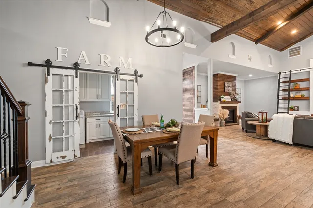 a living room with furniture a flat screen tv and kitchen view
