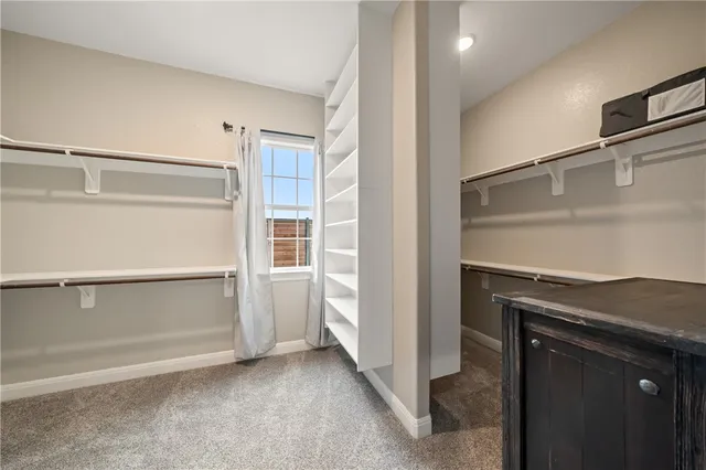 a utility room with cabinets washer and dryer