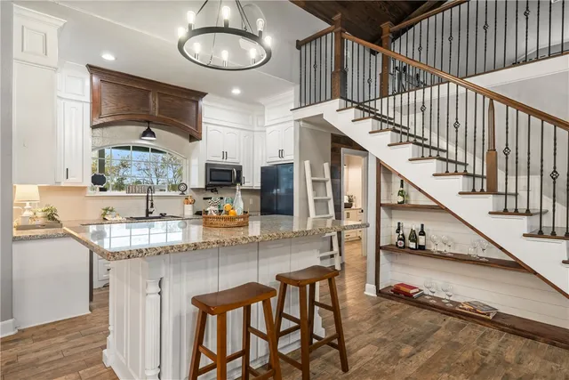 a bathroom with a granite countertop sink a mirror and a shower