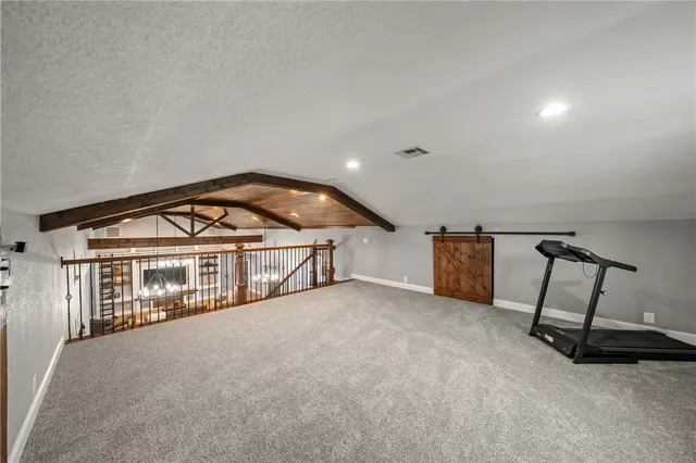 a view of a hallway with a fireplace and a chandelier