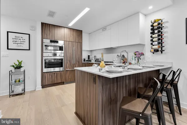 a kitchen with a table chairs stove and refrigerator
