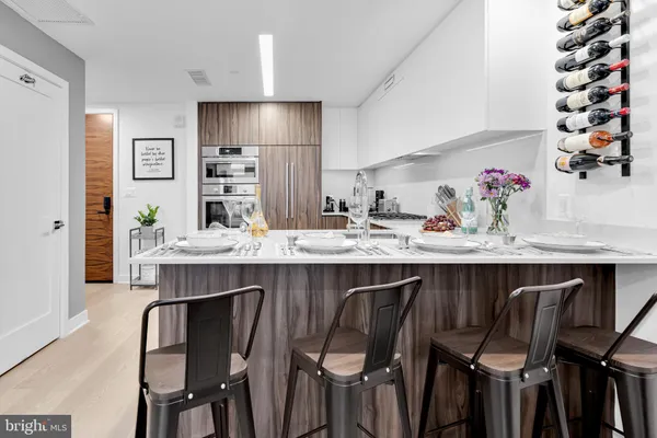 a kitchen with a table chairs stove and cabinets