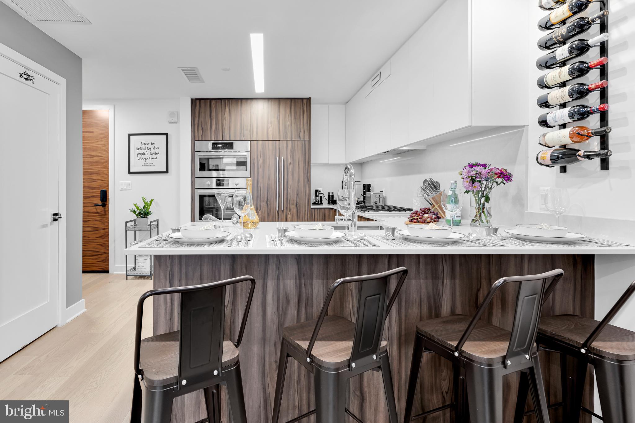 37 L Street Southeast, Unit 308 Washington, DC 20003 - Photo 12 of 43 a kitchen with a table chairs stove and cabinets