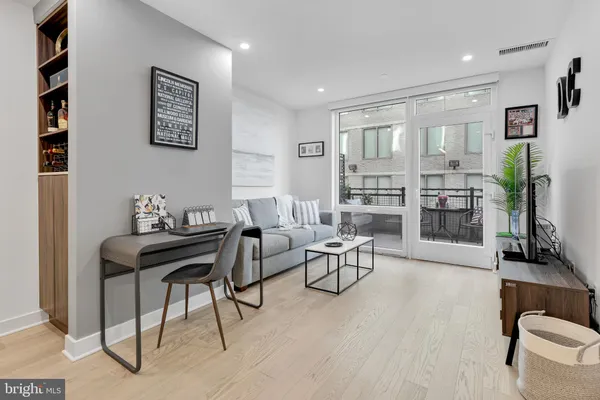 a living room with furniture and wooden floor