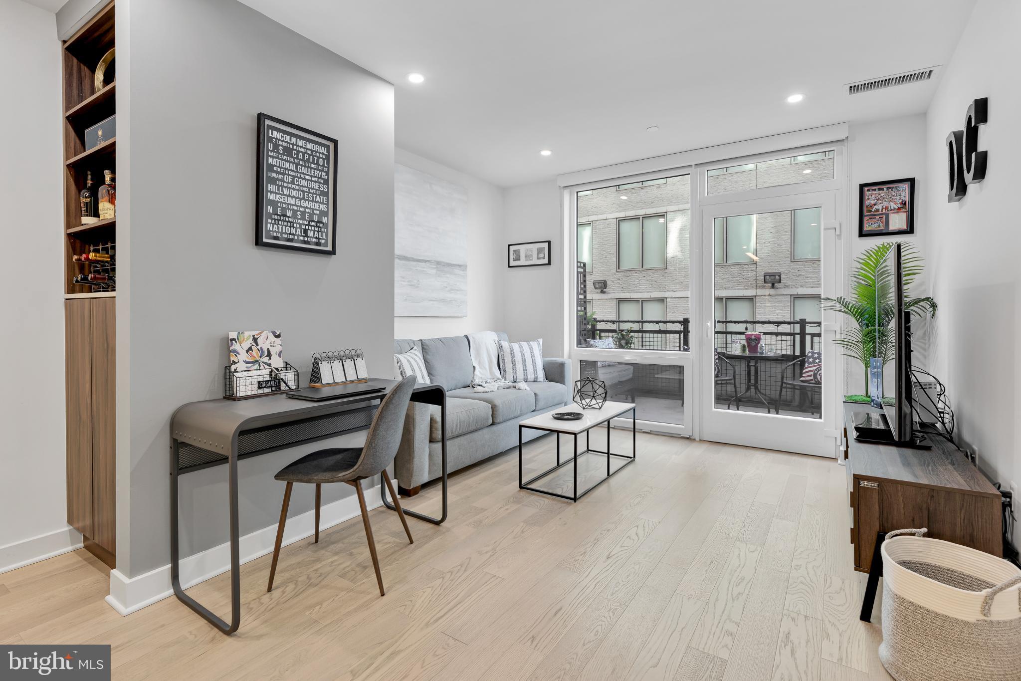 37 L Street Southeast, Unit 308 Washington, DC 20003 - Photo 15 of 43 a living room with furniture and wooden floor