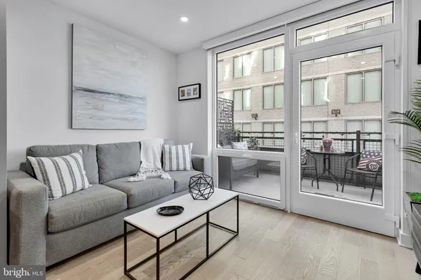 a living room with furniture and a floor to ceiling window