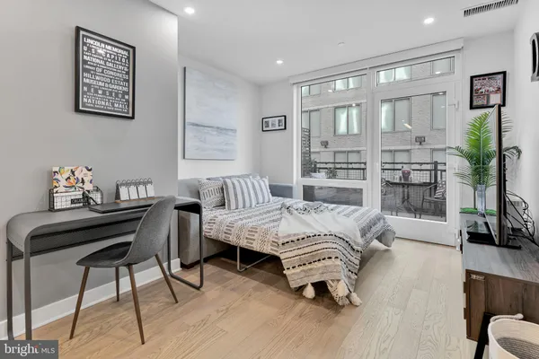 a bedroom with furniture and a wooden floor