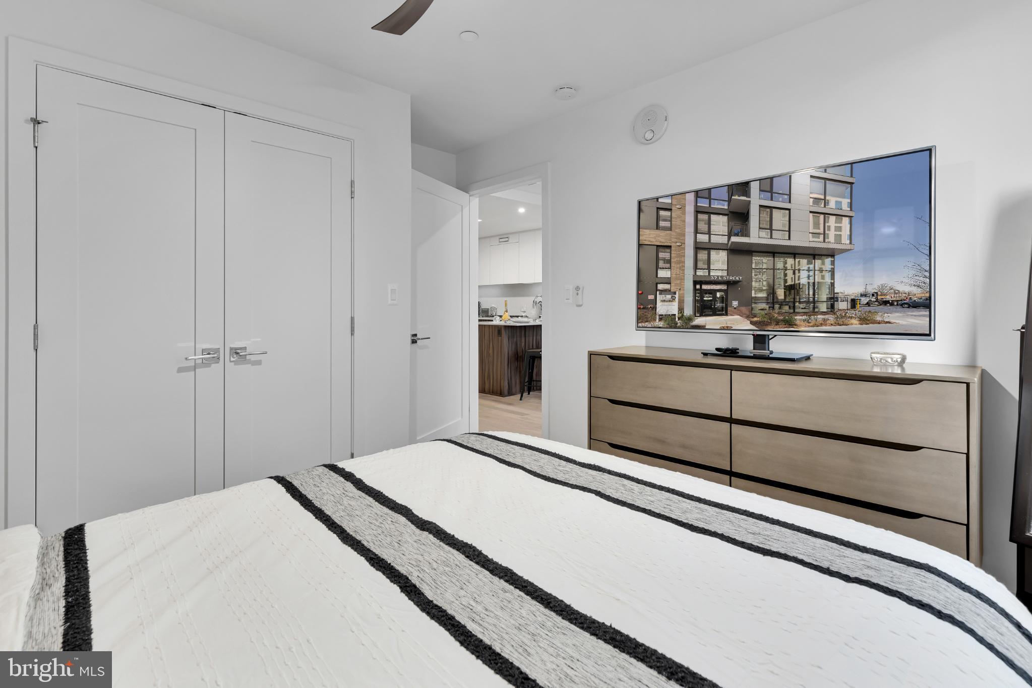 37 L Street Southeast, Unit 308 Washington, DC 20003 - Photo 21 of 43 a bedroom with a bed and a book shelf