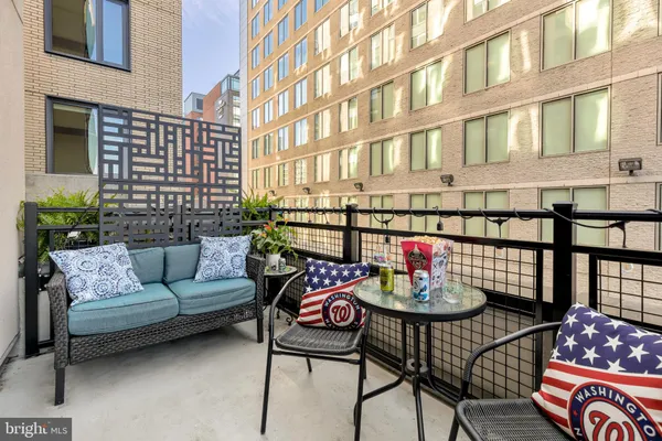 a view of a patio with couches and a potted plant on a table